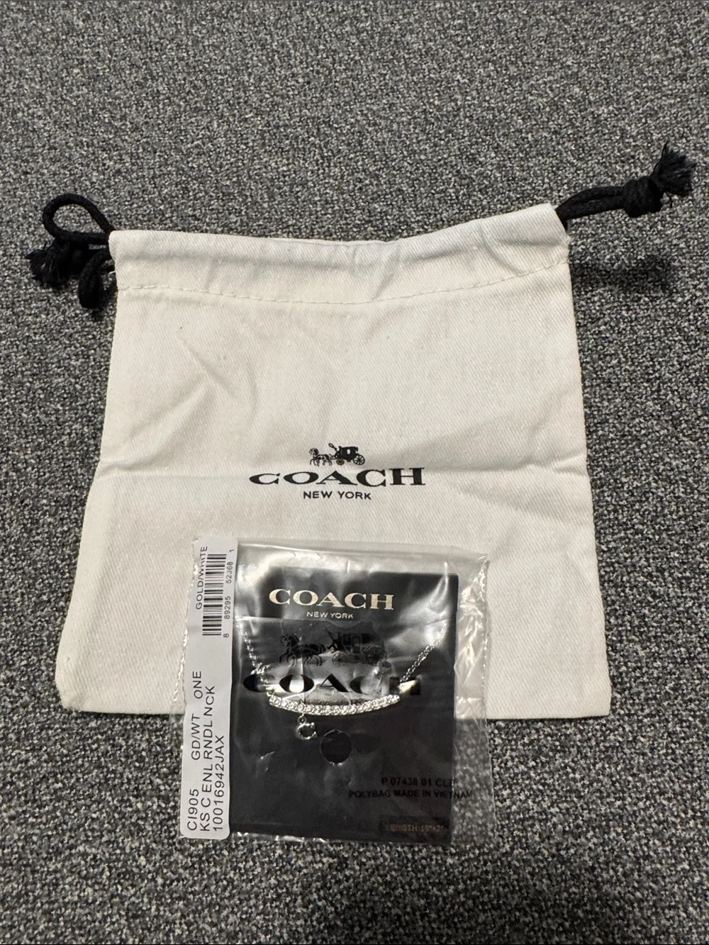 Coach Silver-Tone necklace with White Drawstring Pouch